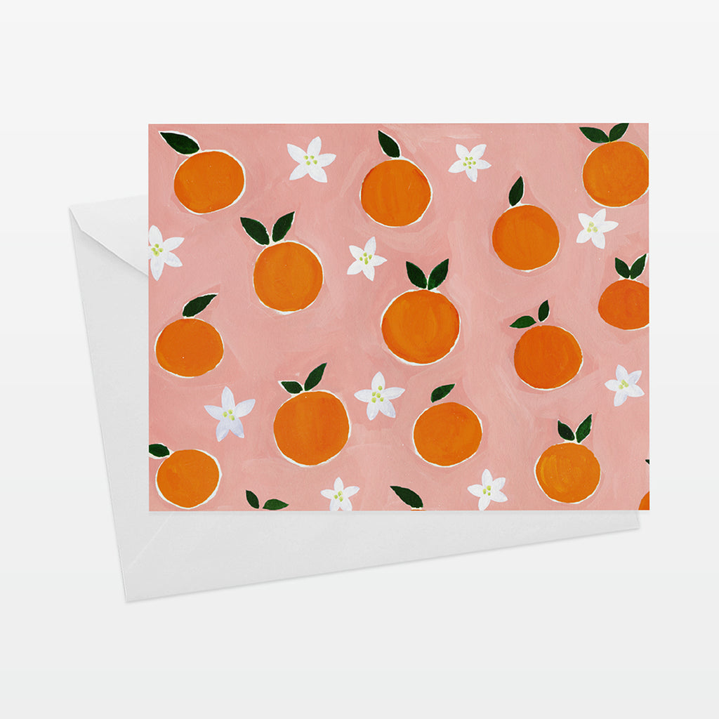 A2 Horizontal everyday card with oranges pattern on coral pink ground. Shown with white envelope.