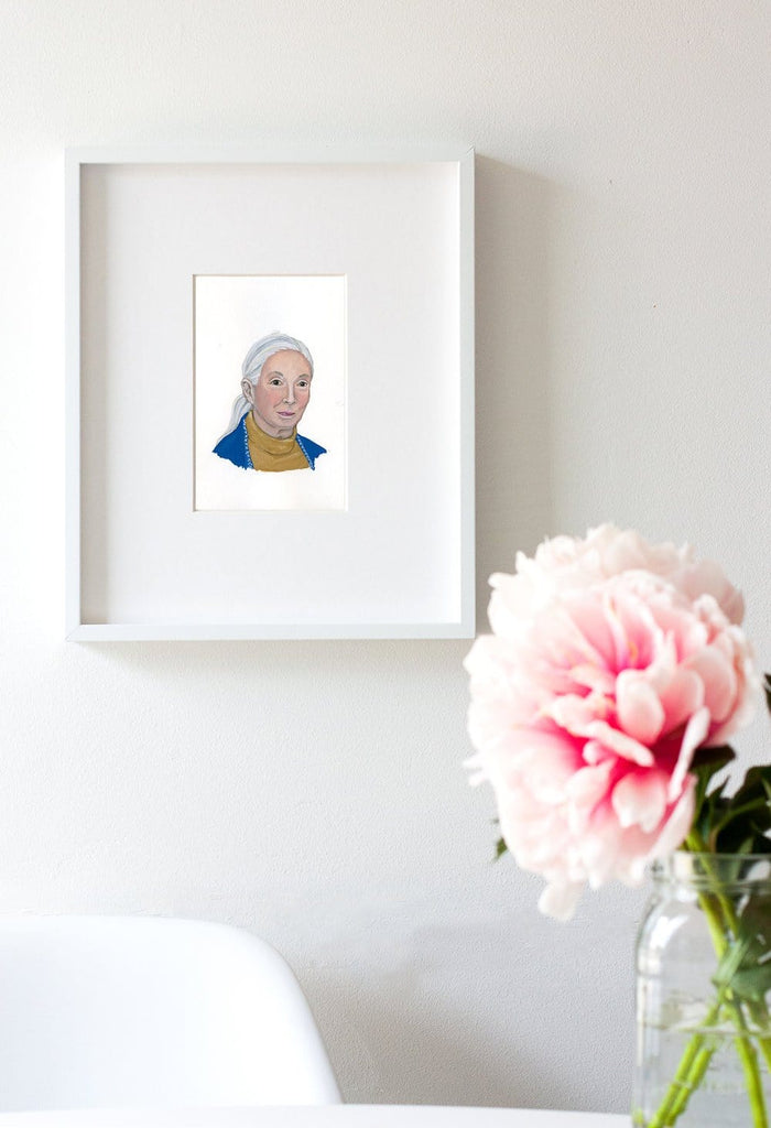 Jane Goodall portrait in gouache by Liz Langley framed in white frame