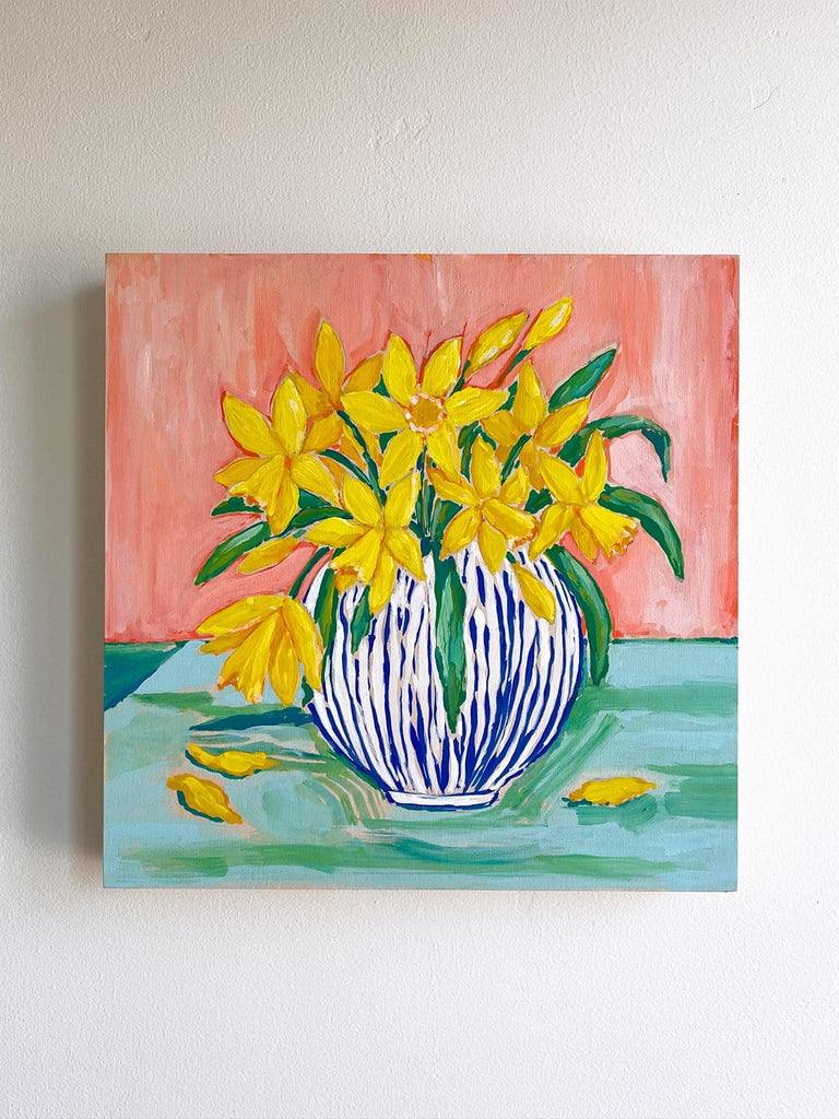 12x12 inch acrylic painting of a bouquet of daffodils bursting from a blue and white striped vase, on a coral and aqua background by Liz Langley.