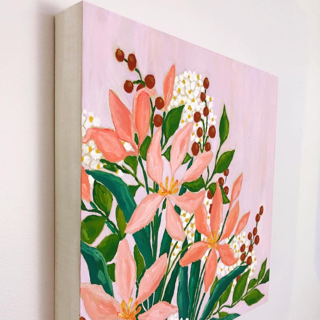 12x12 inch acrylic painting of a bouquet with pink lilies, vibrant green leaves, rust red berries and clouds of white and yellow tiny flowers on a warm lavender background by Liz Langley. The painting is hung on a wall at an angle so you can see the edges of the cradled wood panel, painted white. 