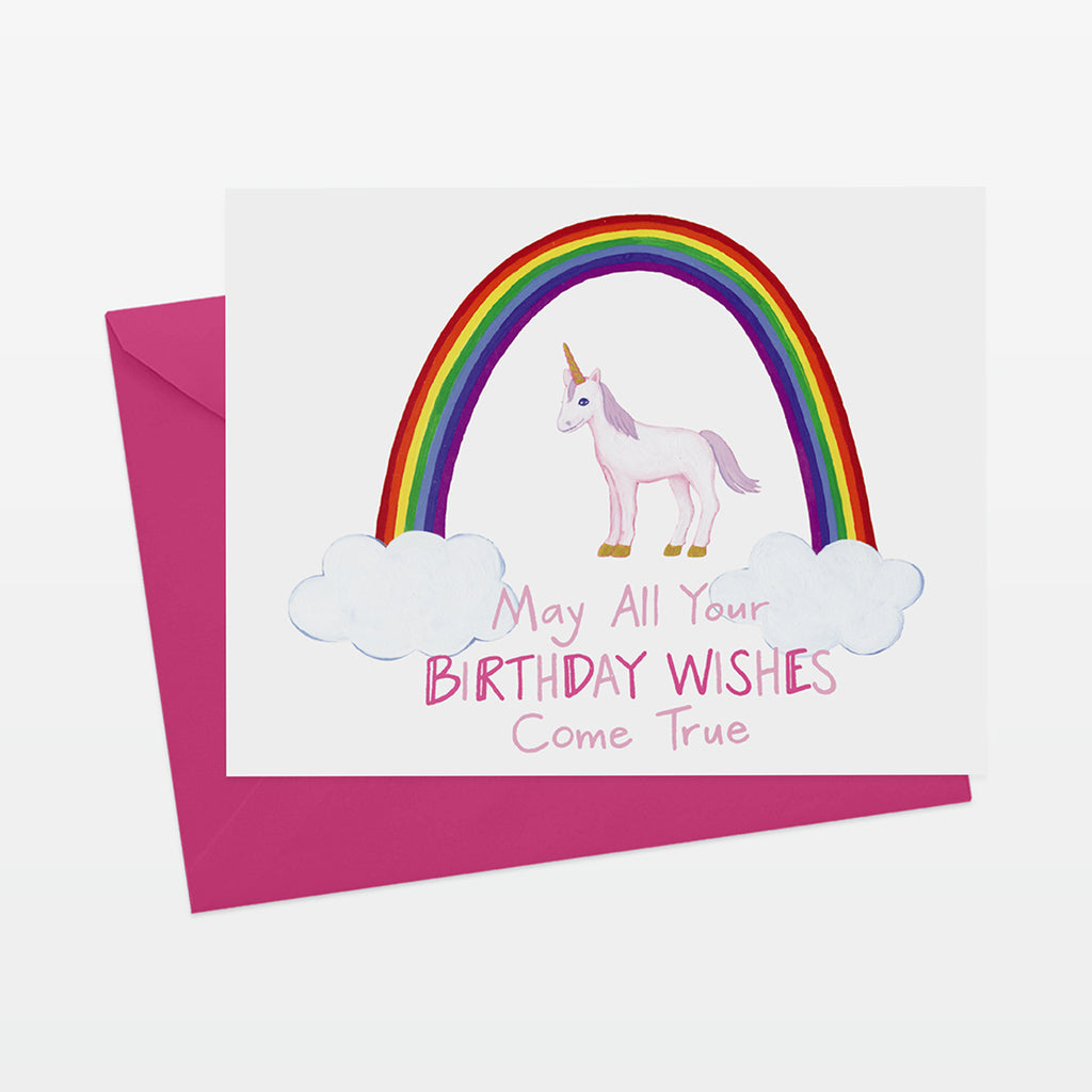 A2 horizontal birthday card with unicorn and rainbow illustration. reads may all your birthday wishes come true. shown with bright pink envelope.