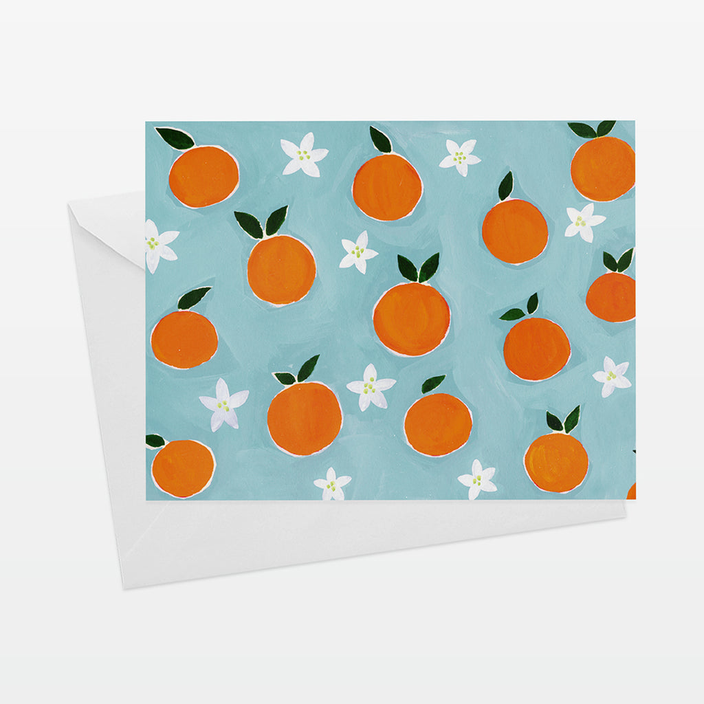 A2 Horizontal everyday card with oranges pattern on aqua ground. Shown with white envelope.