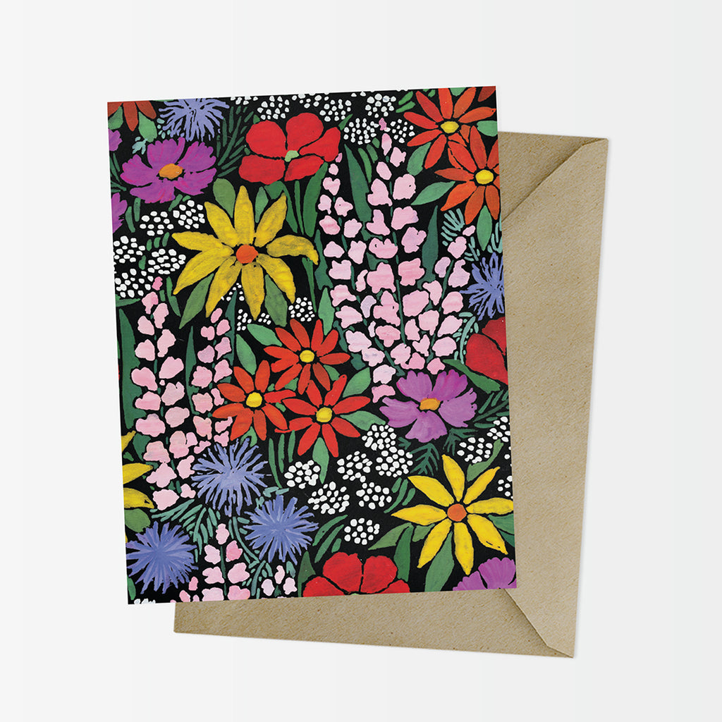 A2 greeting card covered in a painted field of colorful wildflowers on top of a coordinating kraft envelope