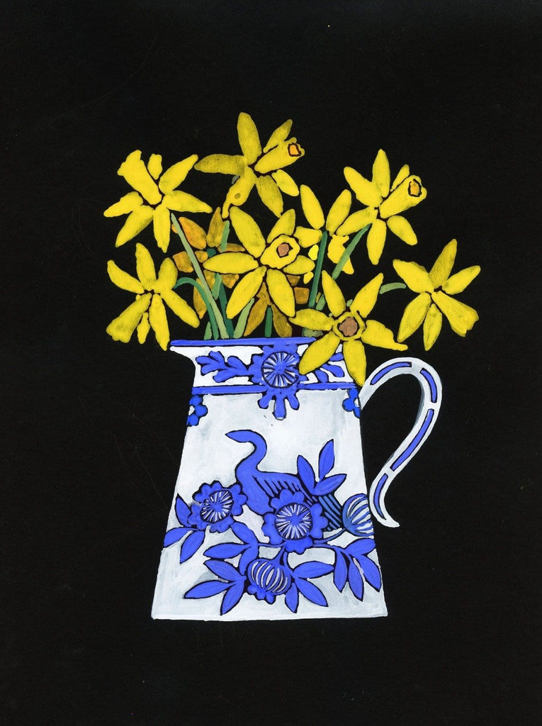 yellow daffodils in a blue and white vase