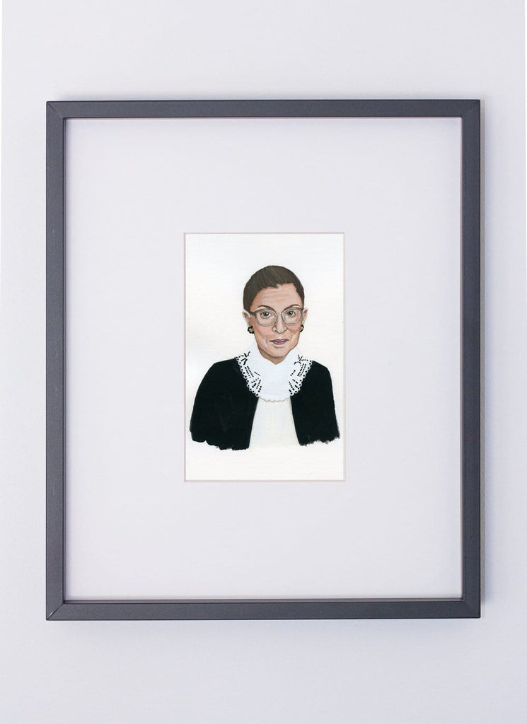 Ruth Bader Ginsberg portrait in gouache by Liz Langley framed in black frame