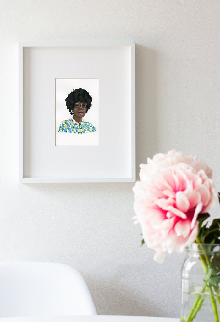 Shirley Chisholm portrait in gouache by Liz Langley framed in white frame
